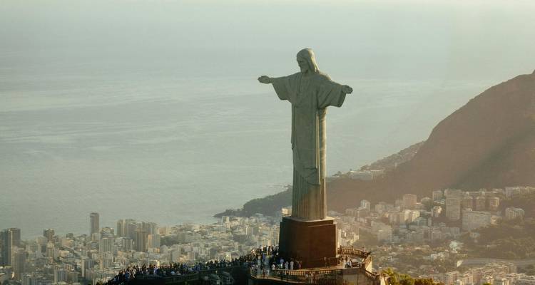 The Christ the Redeemer statue overlooking Rio de Janeiro with cityscape in the background.