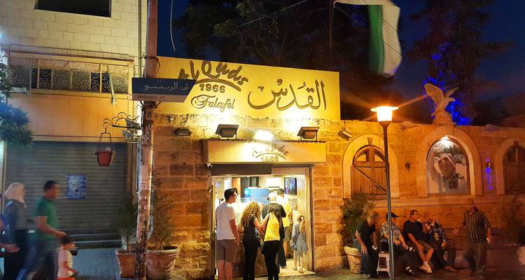 Menschen versammelten sich nachts vor traditionellen Gebäuden.