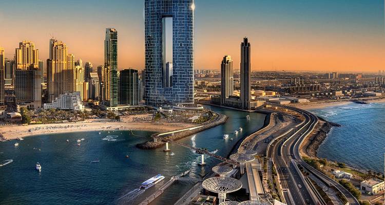 Dubai skyline with beach and modern buildings.