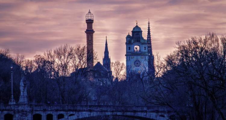 Cityscape silhouette with church towers at dusk.