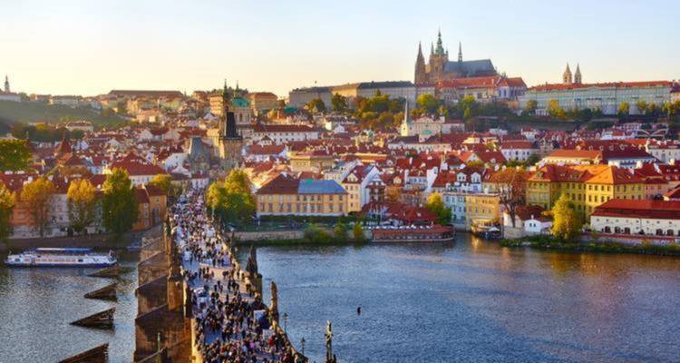 Panoramic view of Prague with Vltava River and Charles Bridge.