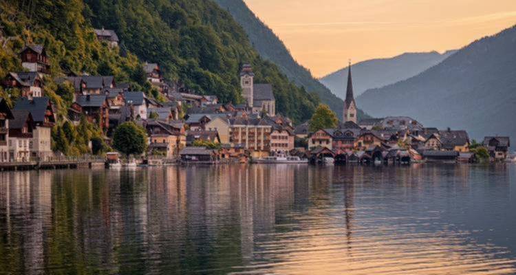 Picturesque lakeside village surrounded by mountains.
