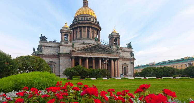 Cathédrale majestueuse avec un dôme doré et des jardins au premier plan.