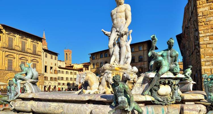 Statue of Neptune in a vibrant urban square.