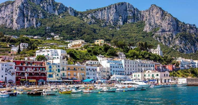 Coastal view of Capri, Italy with colorful buildings and boats.