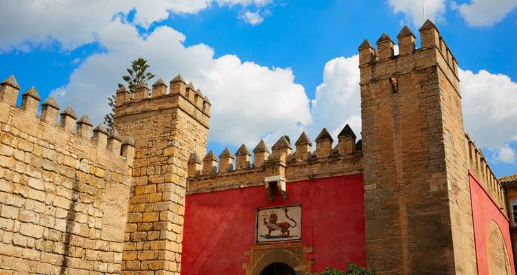 Medieval fort with crenellated walls under a blue sky.