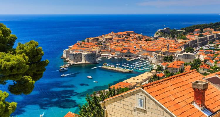 Iconic coastal city with medieval architecture and clear blue waters.
