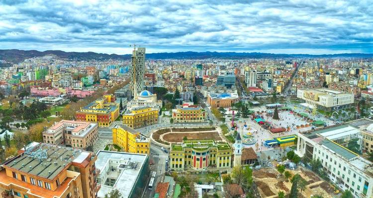 Aerial view of a colorful city with modern and historic buildings.