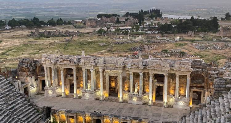 Ruins of an ancient amphitheater with a scenic backdrop