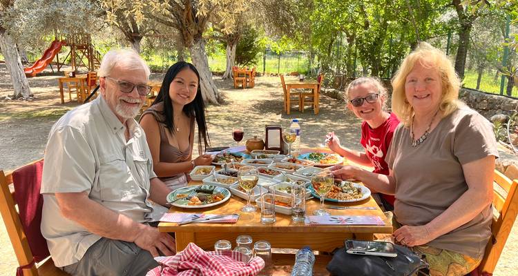 Family enjoying a meal at an outdoor setting.