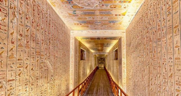 Intérieur d'un tombeau égyptien antique avec des hiéroglyphes vibrants sur les murs et le plafond.