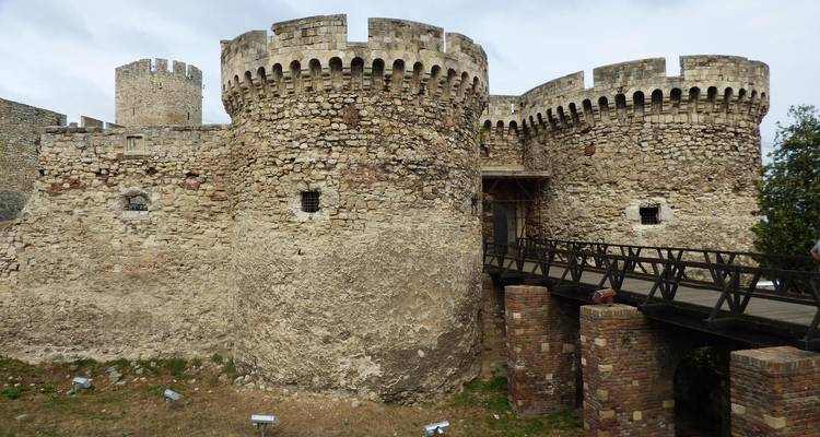 Stone fortress with a bridge in daylight.