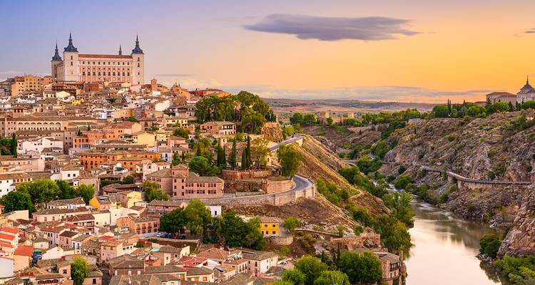 Sunset scene of the Alhambra palace in Granada with Sierra Nevada in the background.