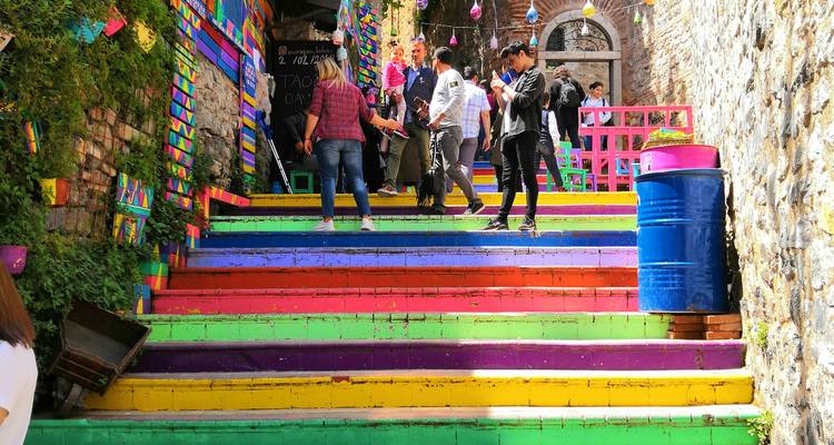 Escaliers aux couleurs vives avec plusieurs personnes qui marchent.