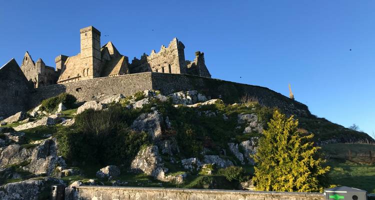A stone castle on a hill against a clear sky.