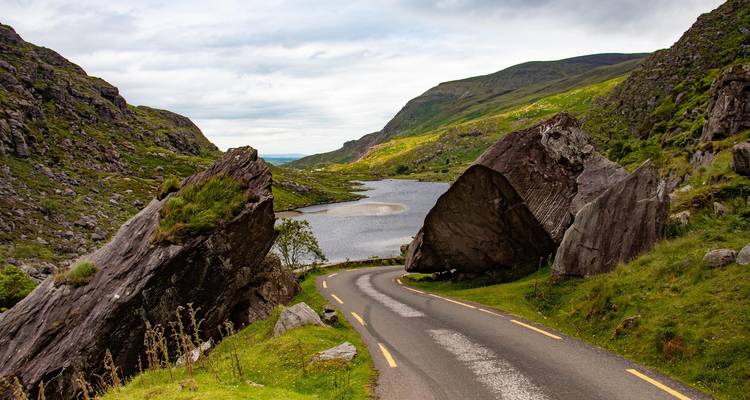 A winding road through a rocky landscape with a scenic view.