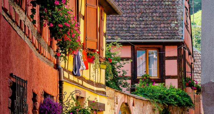 Colorful half-timbered houses adorned with flowers.