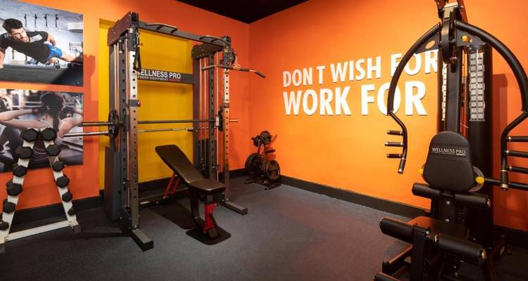 Well-equipped gym with motivational posters.