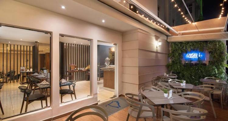 Outdoor dining area with modern design and greenery.