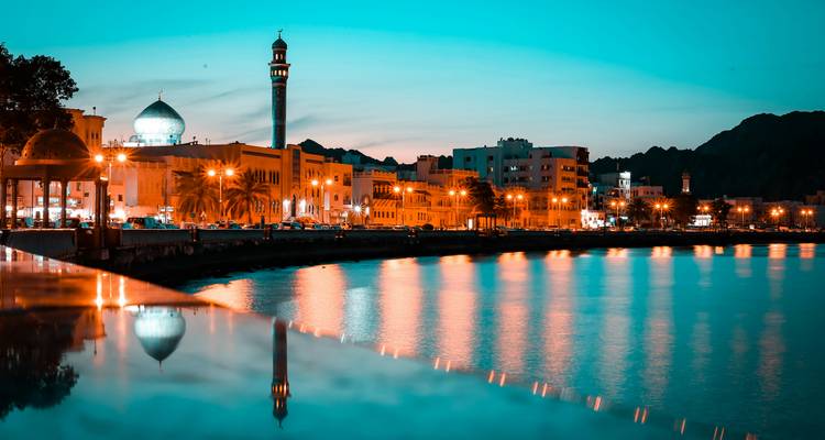 Front de mer de la ville au crépuscule avec des reflets d'éclairage