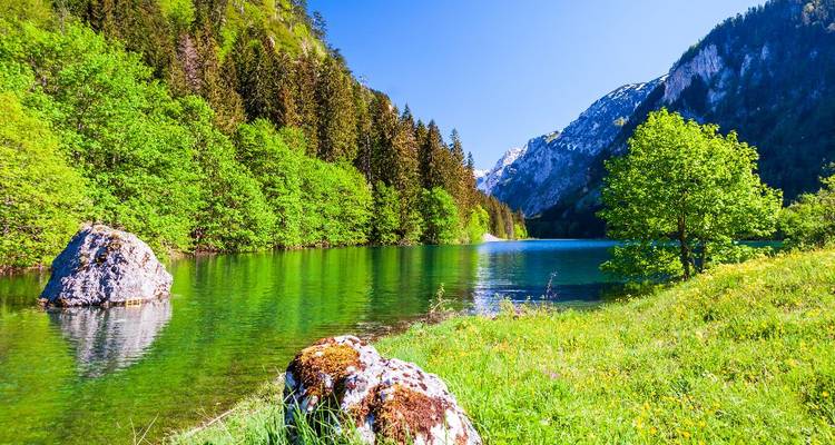 Peaceful lake scene with mountains in the background.