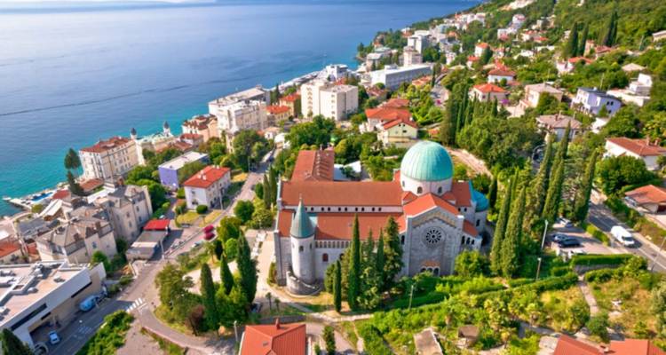 Luchtfoto van een kustplaats met een kerk en omliggende gebouwen.