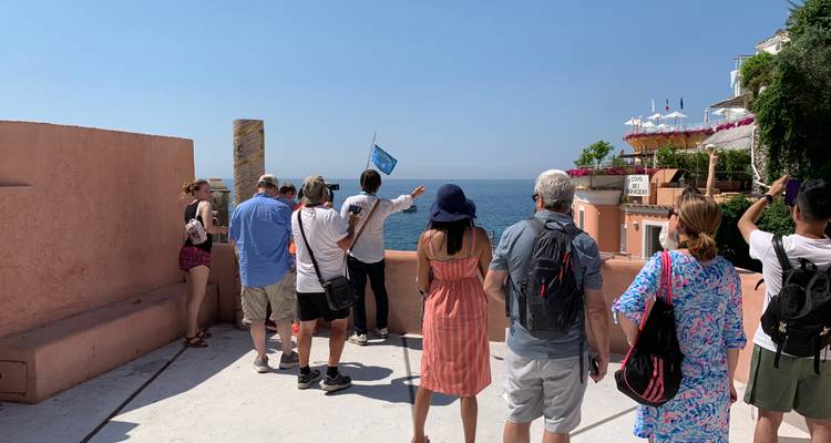 Tourists standing in front of the sea in Positano.