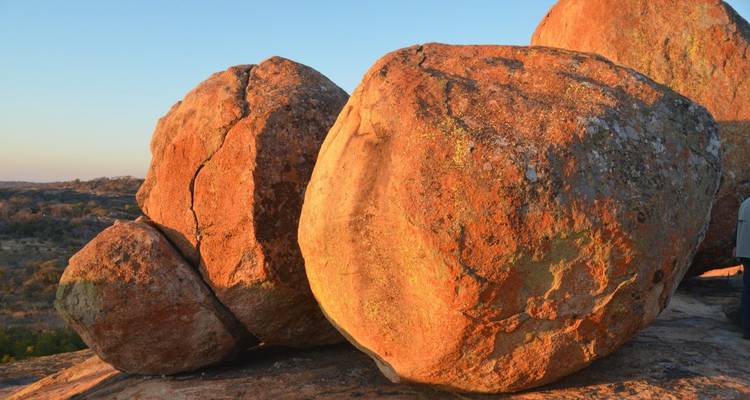 Large boulders on a rocky landscape at dusk.