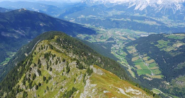 Aerial view of a mountainous landscape with green valleys.