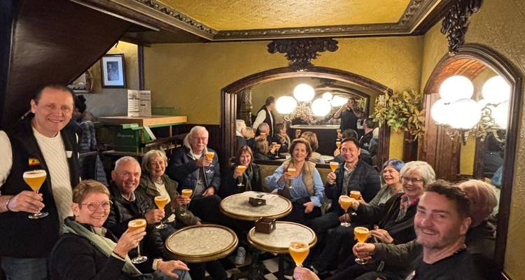 Caminantes felices alzando cervezas artesanales dentro de una taberna acogedora y cálidamente iluminada