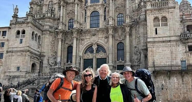Group of people posing in front of a historic cathedral.