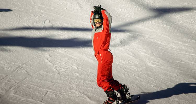 Snowboarder enjoying a ride down a snowy slope.