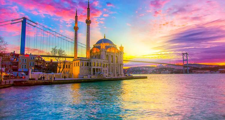 Scenic view of a mosque and bridge at sunset.