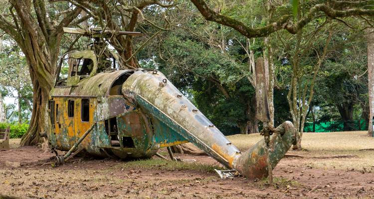 Restos de helicóptero viejo y desgastado en un entorno forestal.