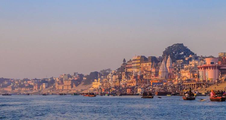 Blick auf die Ghats von Varanasi entlang des Ganges bei Sonnenuntergang.