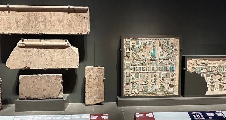 Reliquias de piedra antiguas con jeroglíficos exhibidas en un museo.