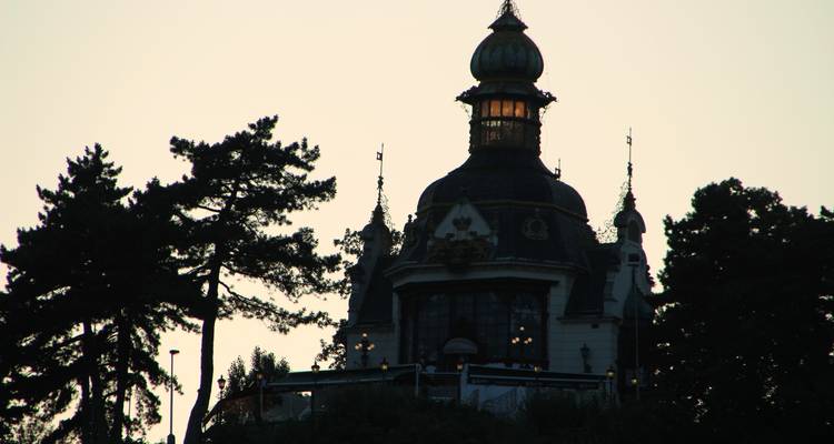 A silhouette of a domed building at dusk.
