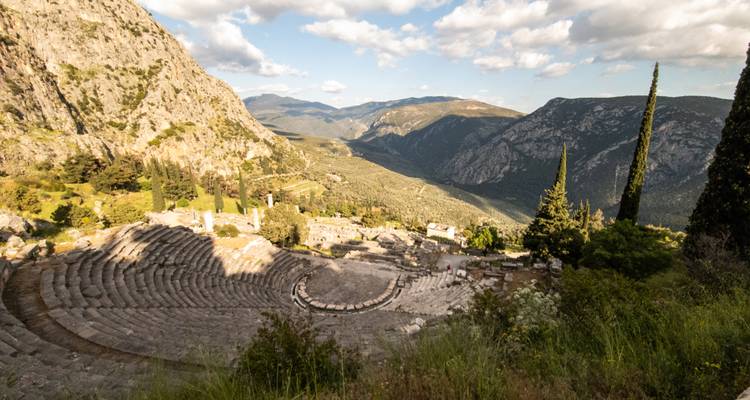 Anfiteatro griego antiguo rodeado de montañas pintorescas.