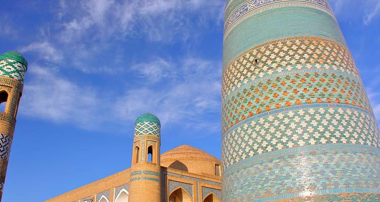 Patterned minaret and domes with vibrant tiles.