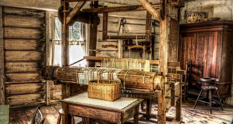 Telar vintage y configuración de tejido en un interior rústico.