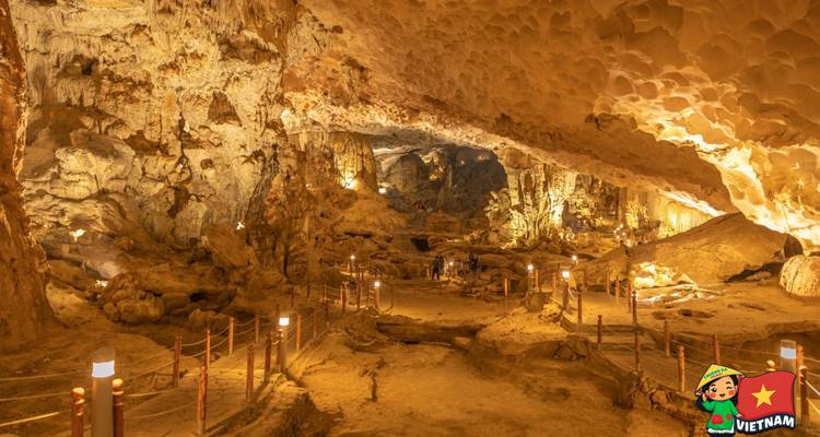 Verlichte grot interieur met stalactieten en looppad.