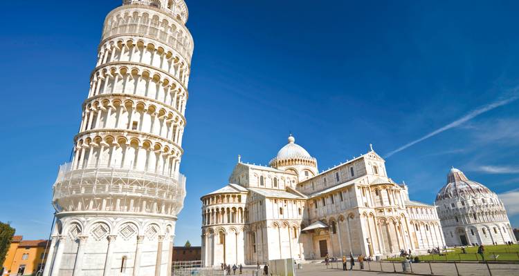 La Tour penchée, la cathédrale et le baptistère de Pise se dressent contre un ciel bleu vif par une journée ensoleillée.