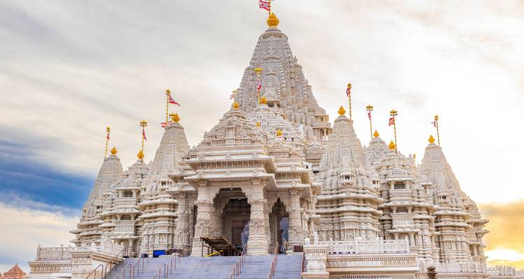 Impresionante templo blanco con tallados intrincados y banderas.