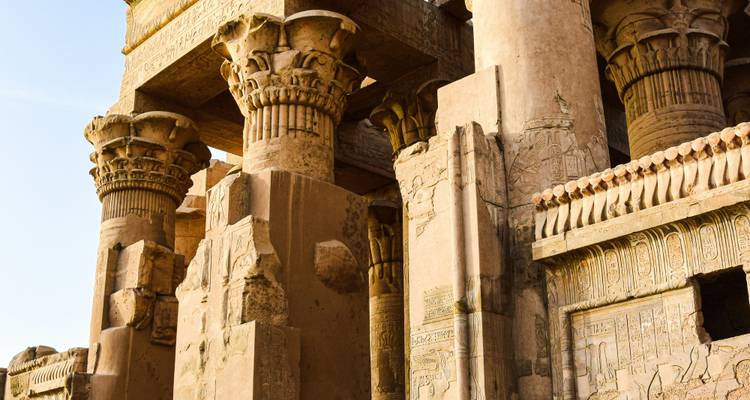 Gros plan de sculptures détaillées sur des piliers de temple antique.