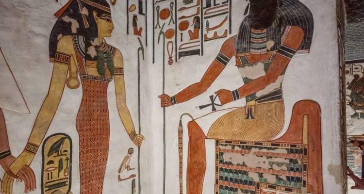 Représentation murale égyptienne de figures avec des hiéroglyphes.