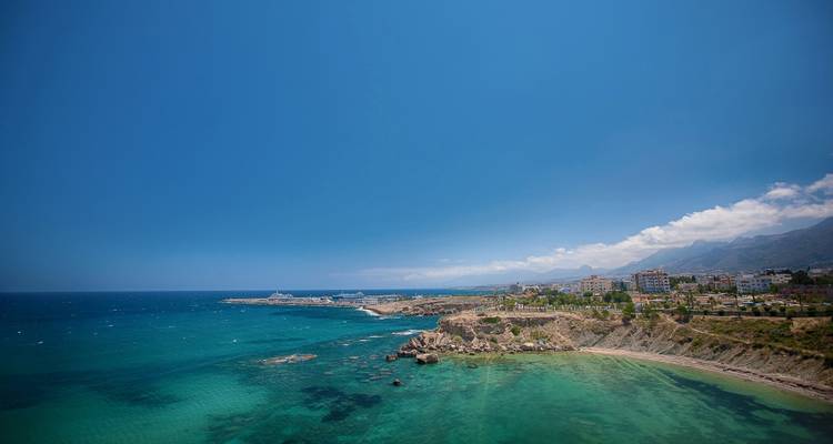 Scenic coastal view with clear blue skies and ocean.