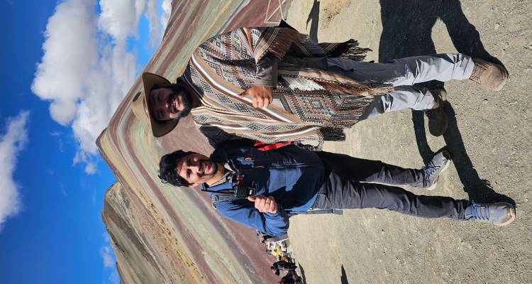 Deux hommes posant avec les pouces levés au Rainbow Mountain.