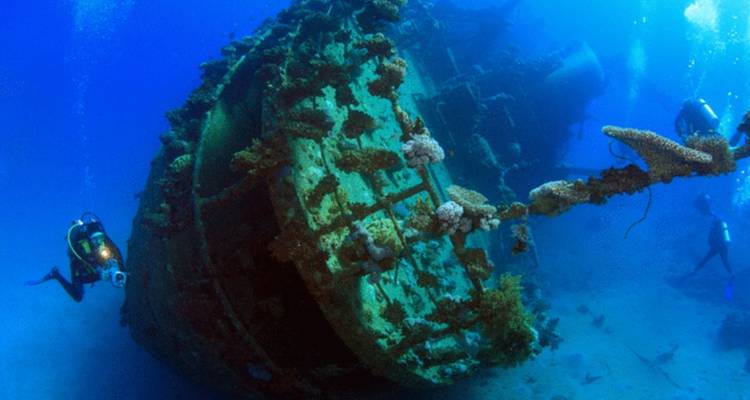 Plongeurs explorant l'épave d'un navire coulé sous l'eau.