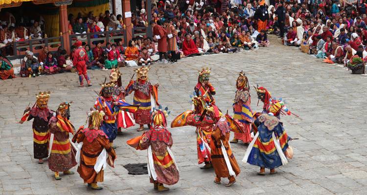 Colorful traditional dance in a crowded festival setting.