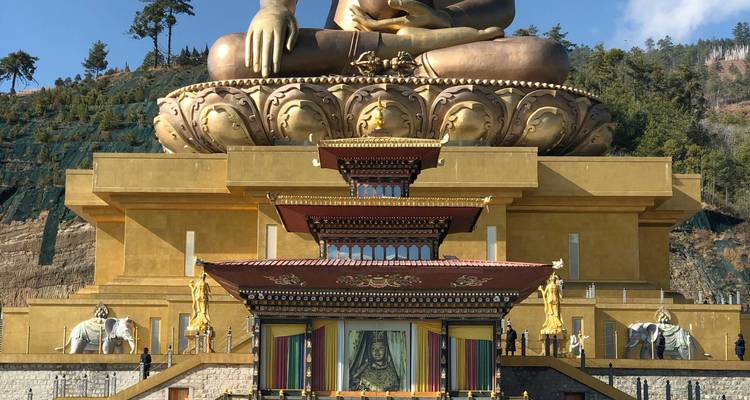 A large golden Buddha statue in a temple setting.
